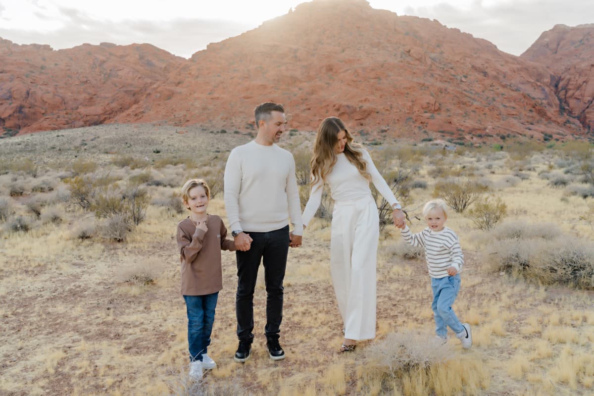 Family of four walking hand in hand at Red Rock Canyon, Las Vegas